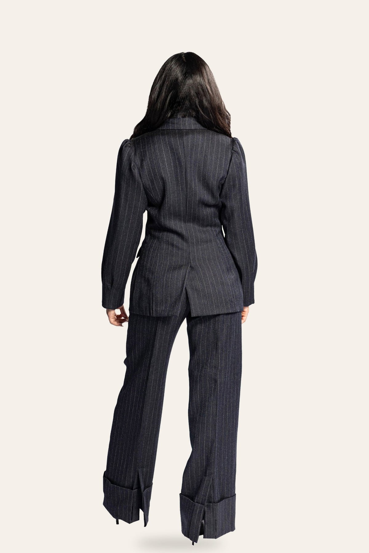 DAÉIN FW26 navy pinstripe wool suit with wide-leg turn-up trousers, women's — full-length back view