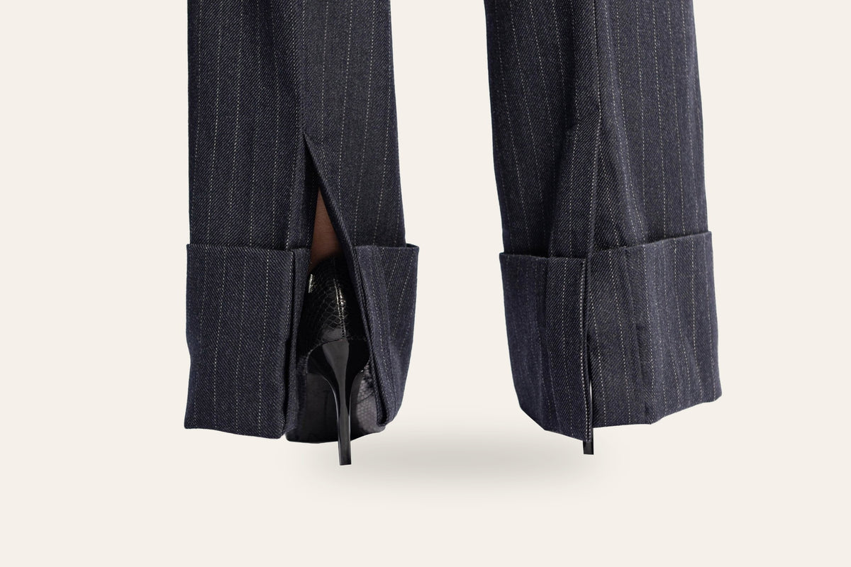 DAÉIN FW26 navy pinstripe wide-leg trousers, women's — deep turn-up hem detail